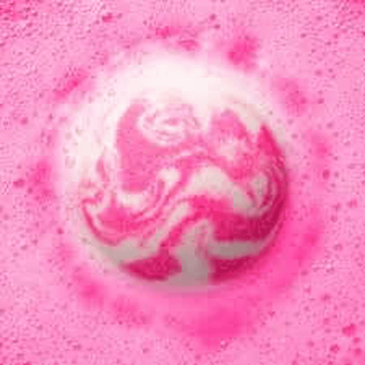 Vibrant pink and white bath bomb by Naked Mermaid Soapery fizzing in water, creating rich foam and swirling color for a luxurious, fun self-care experience.
