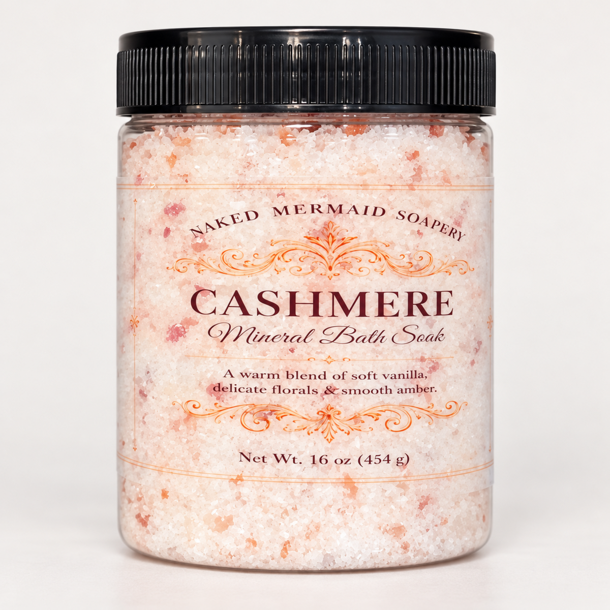 Clear 16 oz jar of Naked Mermaid Soapery Cashmere Foaming Mineral Bath Soak, featuring pink Himalayan and Dead Sea salts, a black lid, and decorative label.