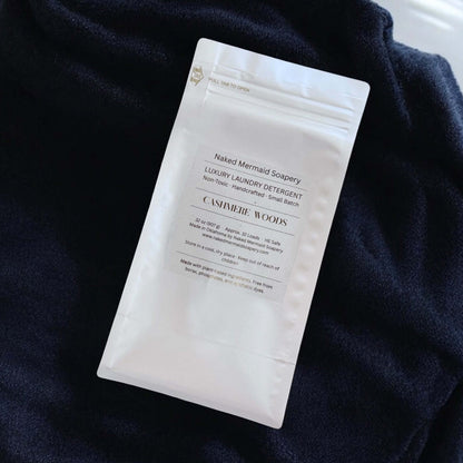 Naked Mermaid Solpery laundry detergent packet on a dark fabric background