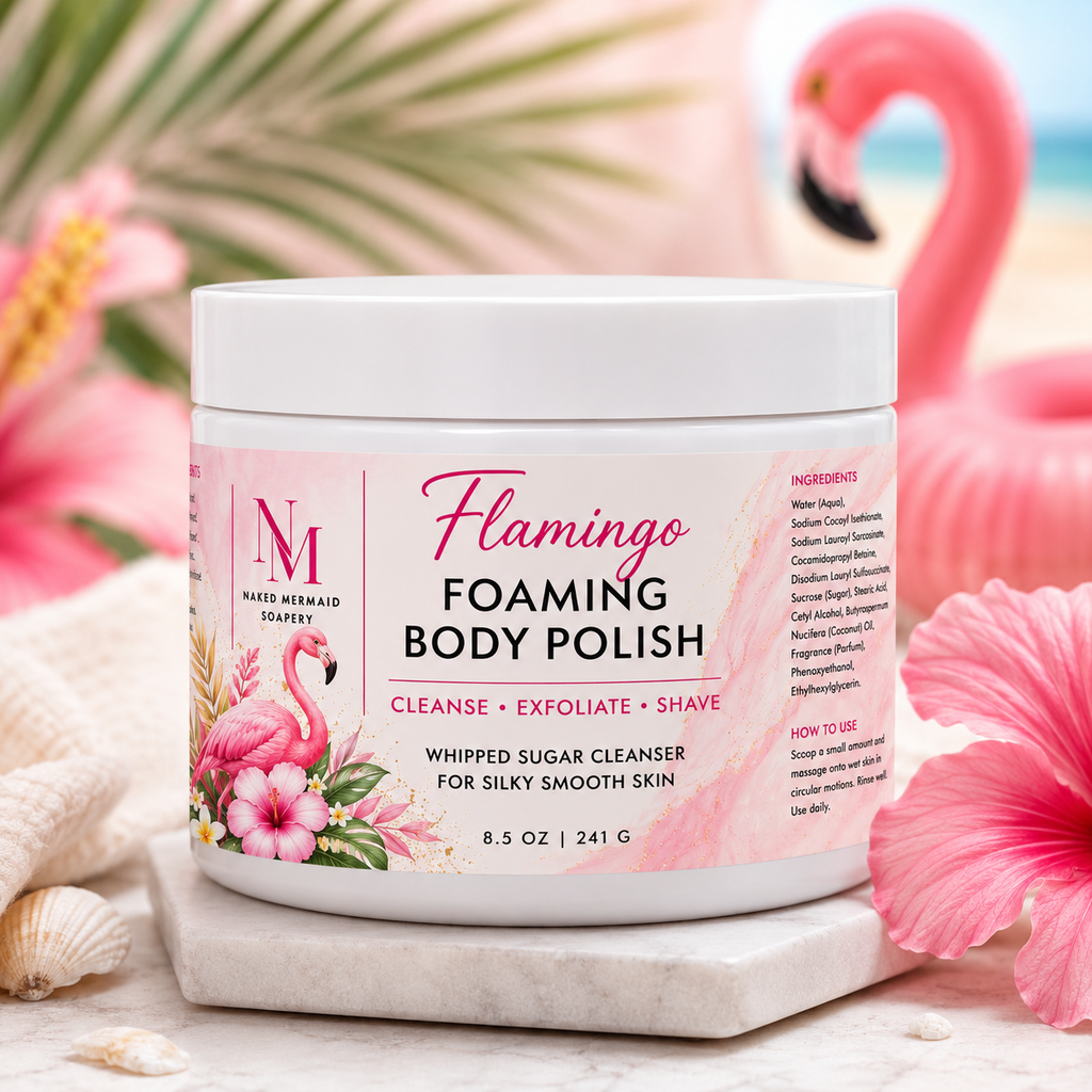 Flamingo Foaming Body Polish by Naked Mermaid Soapery in an 8.5 oz white jar with a vibrant tropical pink label. This whipped sugar body polish gently cleanses, exfoliates, and creates a rich lather for shaving while leaving skin silky smooth and beautifully scented with a bright, playful tropical fragrance.