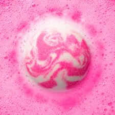 Pink and white marbled bath bomb with bubbles on a pink background