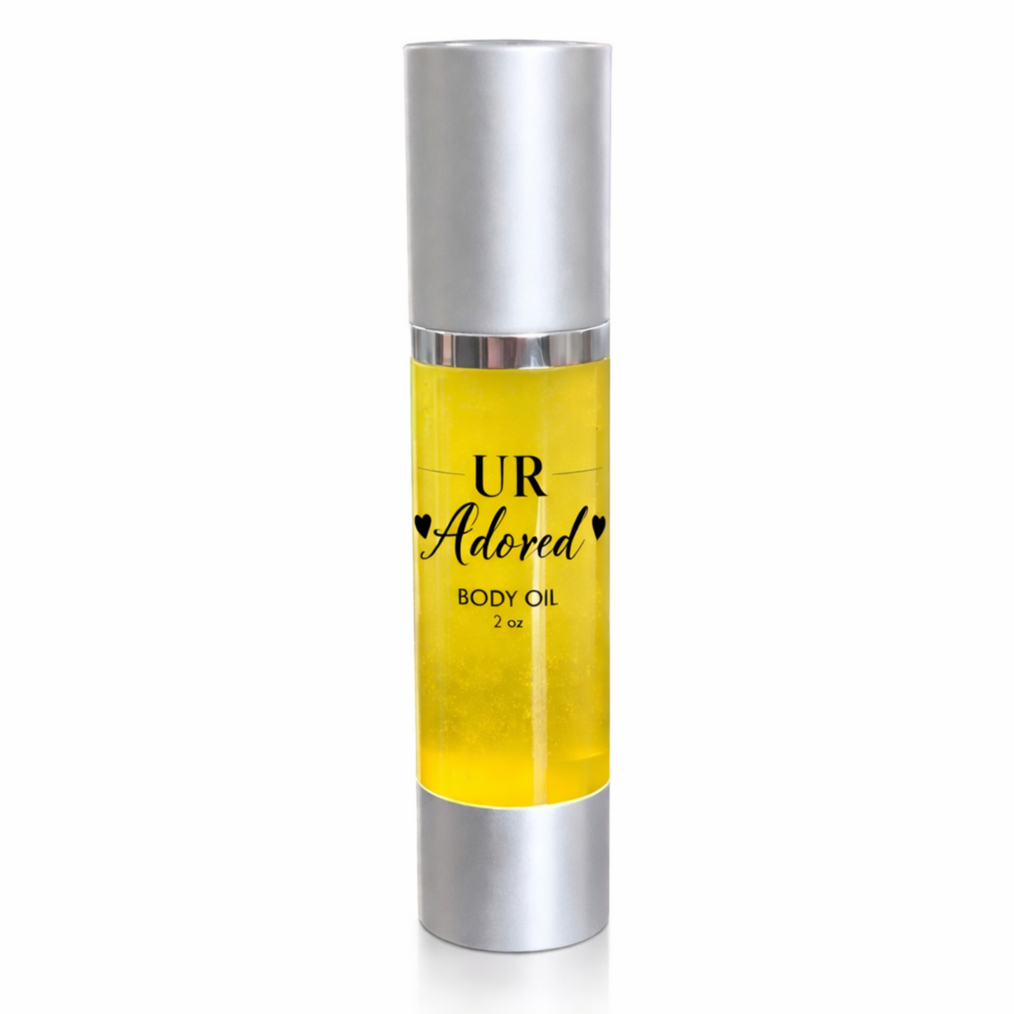 UR Adored 2 oz body oil in a clear airless pump bottle with silver cap and base, featuring a clear label with black text and filled with golden jojoba, amla, rosehip, and vitamin E oils on a clean white background.