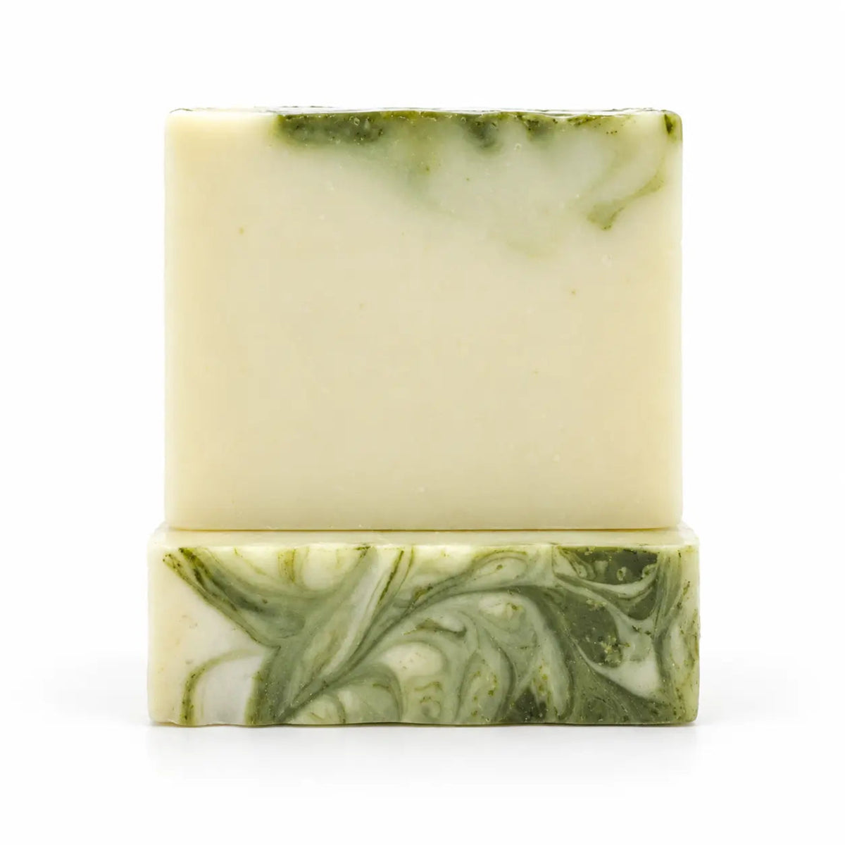 A handmade rectangular bar of soap with a light cream base and green marbled swirls, displayed on a matching green and cream soap block against a white background.