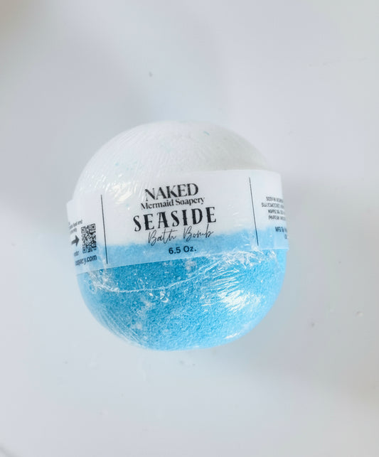 Bath bomb labeled 'Naked Mermaid Soaps' with a white and blue design on a light gray background